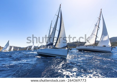 Sailing in the wind through the waves at the Aegean Sea in Greece. Sailing regatta. Luxury yachts.  Royalty-Free Stock Photo #264369773