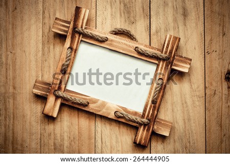 wooden picture frame on old wood plank wall background