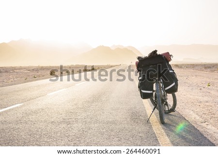 Bicycle standing on road in sunset lights. Adventure background picture 