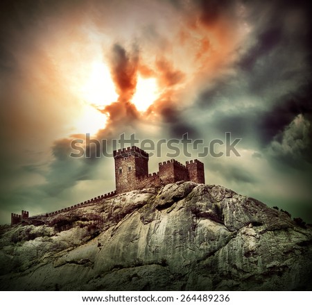 Ancient fortress on the hill under dramatic sky Royalty-Free Stock Photo #264489236