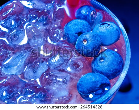 Cold red blueberry drink  with berry . Top view. Close up.