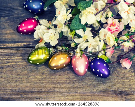 Spring blossoms and easter eggs decoration on rustic wooden background. Retro style toned picture