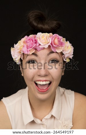 Happy female model wearing floral crown portrait