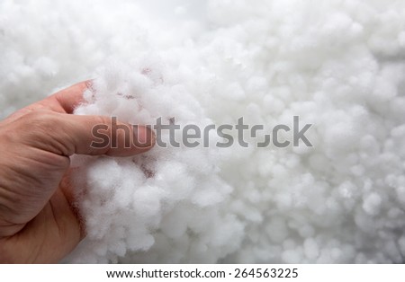 Closeup of a hand taking synthetic filler Royalty-Free Stock Photo #264563225
