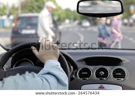 The driver and a pedestrian at a crosswalk Royalty-Free Stock Photo #264576434