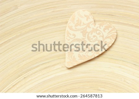 Heart shape symbol over texture of bamboo plate