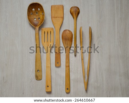 Set of wooden kitchen utensils on wooden background 