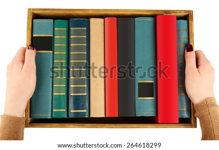Books in wooden box in female hands, top view