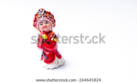 Cute ceramic figure with Chinese's traditional wedding costume clothes or dress. Concept of old fashion Asian bride and groom. Slightly defocused and close-up shot. Isolate on white background. 