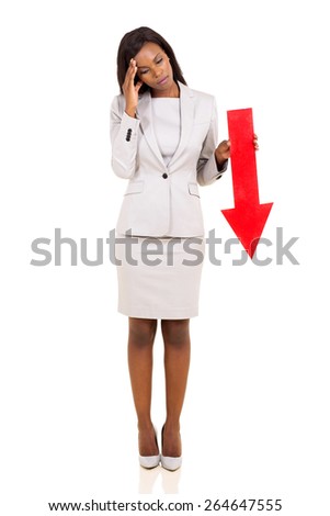 sad african businesswoman holding red arrow pointing down on white background