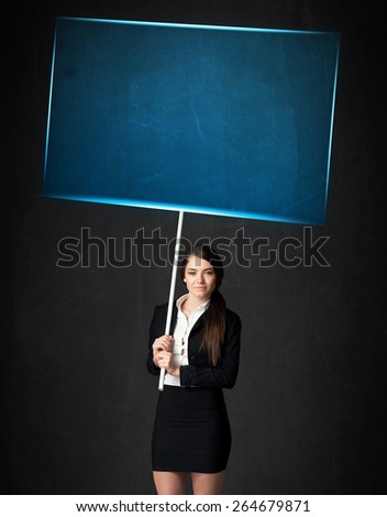 Young businesswoman holding a big, blue board
