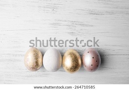 Easter eggs on rustic wooden table. Holiday background. Tinted photo.