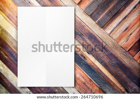 Blank folded paper poster hanging on diagonal wooden wall,Template mock up for adding your design.