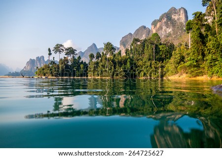Beautiful mountains lake river sky and natural attractions in Ratchaprapha Dam at Khao Sok National Park, Surat Thani Province, Thailand. Royalty-Free Stock Photo #264725627