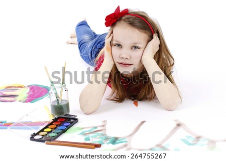 Beautiful little girl drawing with water colors