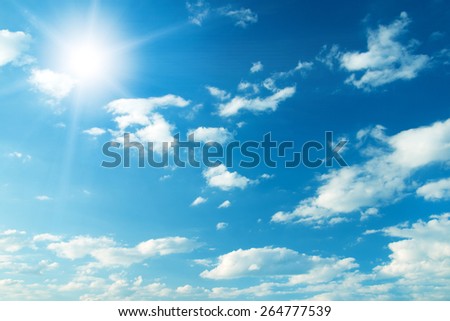 Blue sky with clouds and sun. Royalty-Free Stock Photo #264777539