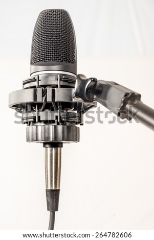 Isolated Microphone in cradle against white background