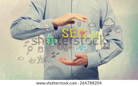 Young man in blue shirt holding SEO concepts