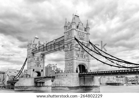 Black and white photograph of London Tower Bridge on the Thames River. It is an iconic symbol of London, United Kingdom.