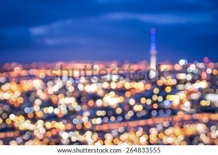 Bokeh of Auckland skyline from Mount Eden after sunset during the blue hour - New Zealand modern city with spectacular nightscape panorama - Blurred defocused night lights Royalty-Free Stock Photo #264833555