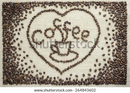 Coffee beans are laid on the fabric in the shape of a heart.