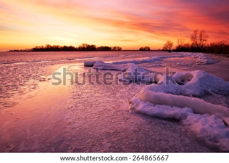 Winter landscape with sunset fiery sky. 