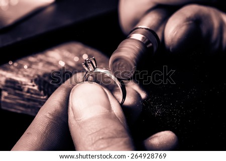 Craft jewelery making. Ring polishing. Macro shot. Monochrome cream tone. Black and white photography. Royalty-Free Stock Photo #264928769