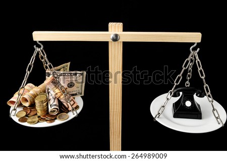 Money and Telephone on a Two Pan Balance
