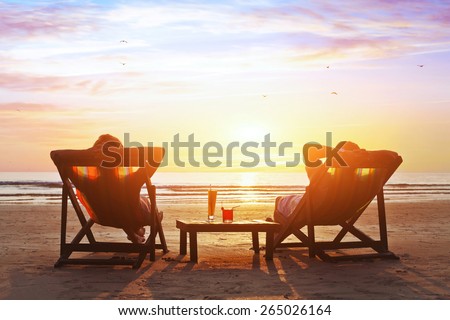 happy couple enjoy luxury sunset on the beach during summer vacations Royalty-Free Stock Photo #265026164