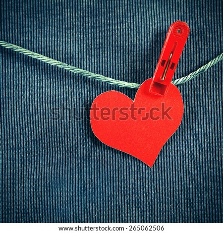 Toned Photo of Red Heart Shape on the Rope on the Textile Background