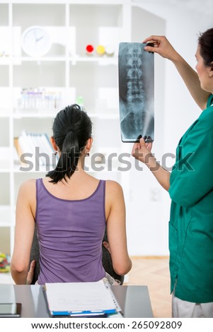 Doctor with patient looking at x-ray. Selective focus