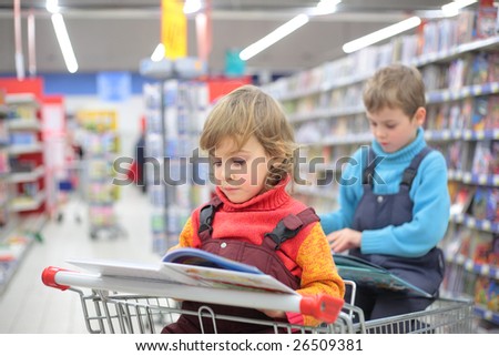 Children in bookshop, focus on little girl