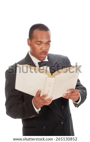 African American preacher reading from a bible, isolated over white
