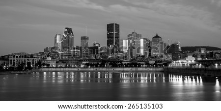 Skyline of downtown Montreal, behind the St Lawrence River,view from the Pierre-Dupuy Street at dusk.