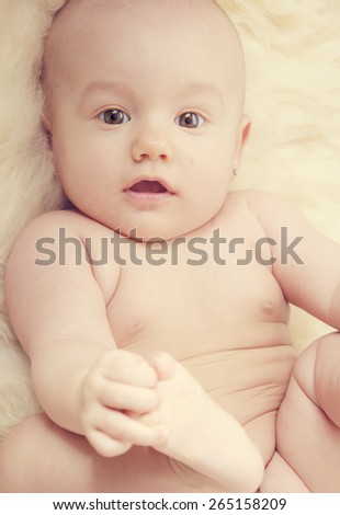 cute happy baby portrait lying on fur
