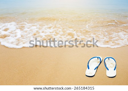 Flipflops on a sandy ocean beach, Tropical vacation concept