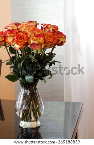 yellow red natural roses in a vase on the table with copy space