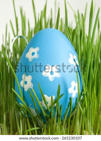 Blue Easter egg with white painted flowers