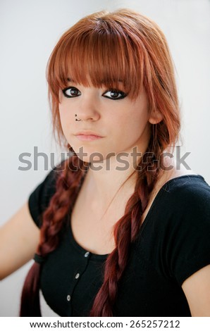 Rebellious teenager girl with red hair smiling
