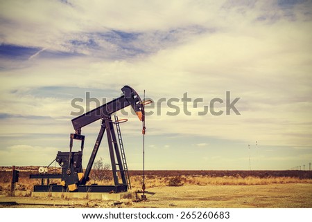 Retro filtered picture of oil pump jack, Texas, USA.