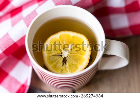 Cup of tea with lemon on the wooden table
