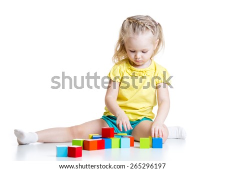 kid girl 3 years old playing  wooden cubes isolated on white