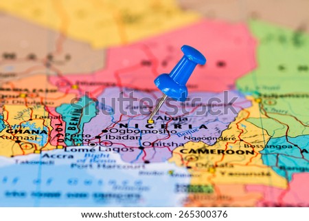 Map of Nigeria with a blue pushpin stuck Royalty-Free Stock Photo #265300376