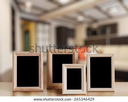 photo frames on the wooden table in the living room