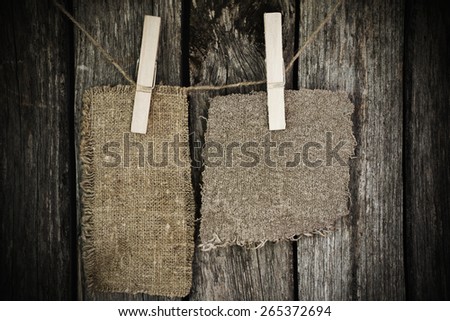 sacking attach to rope with clothes pins on wooden background