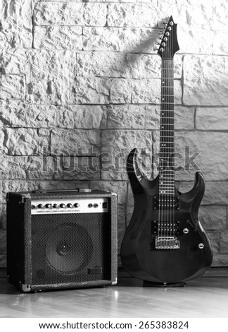 Guitar and amplifier on a stone background
