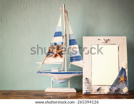 vintage nautical frame with starfish on wooden table. retro filtered image
