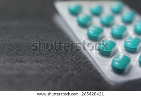 Blister pack of Turquoise medicine pills Close up Royalty-Free Stock Photo #265420421