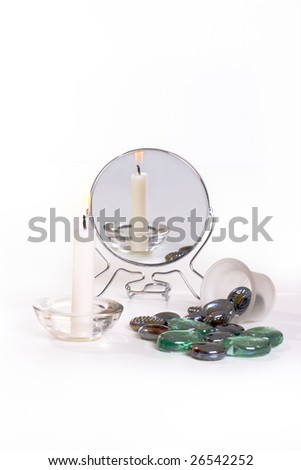 reflection candles and stone in the mirror on the white background