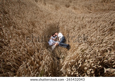 wedding couple in national costume in wheat